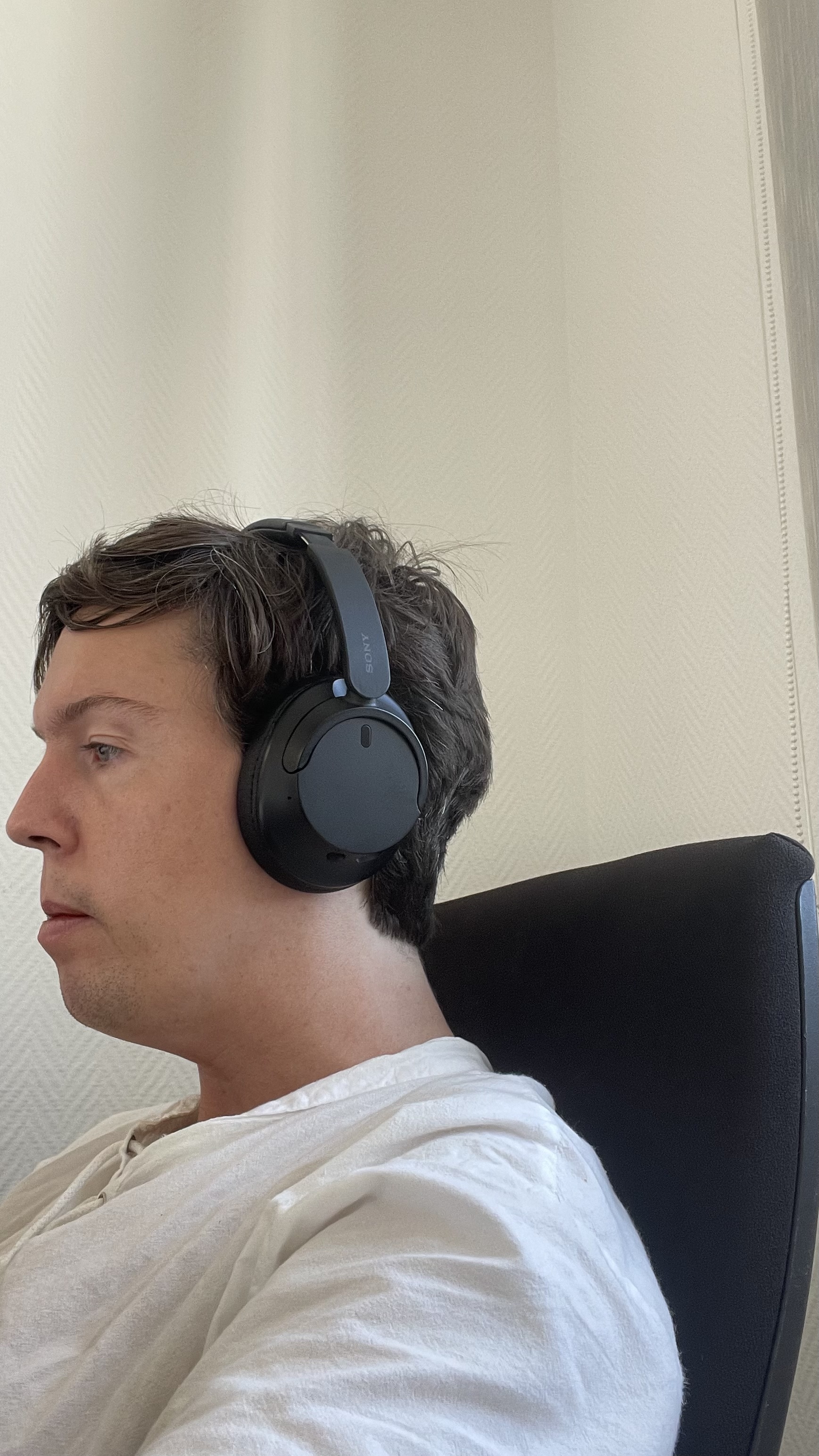 Side profile view showing forward head posture with headphones on
